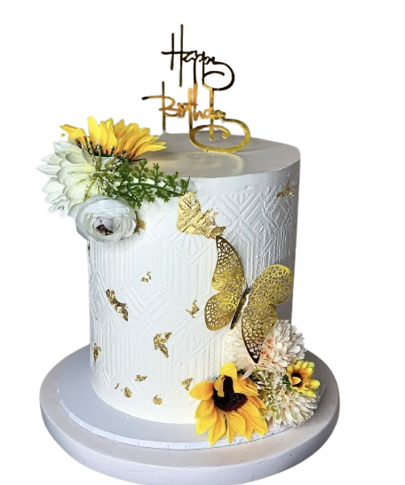 White buttercream cake with embossed texture, decorated with gold foil accents, gold butterfly cut-out, fresh sunflowers and white florals, and a “Happy Birthday” gold acrylic topper.