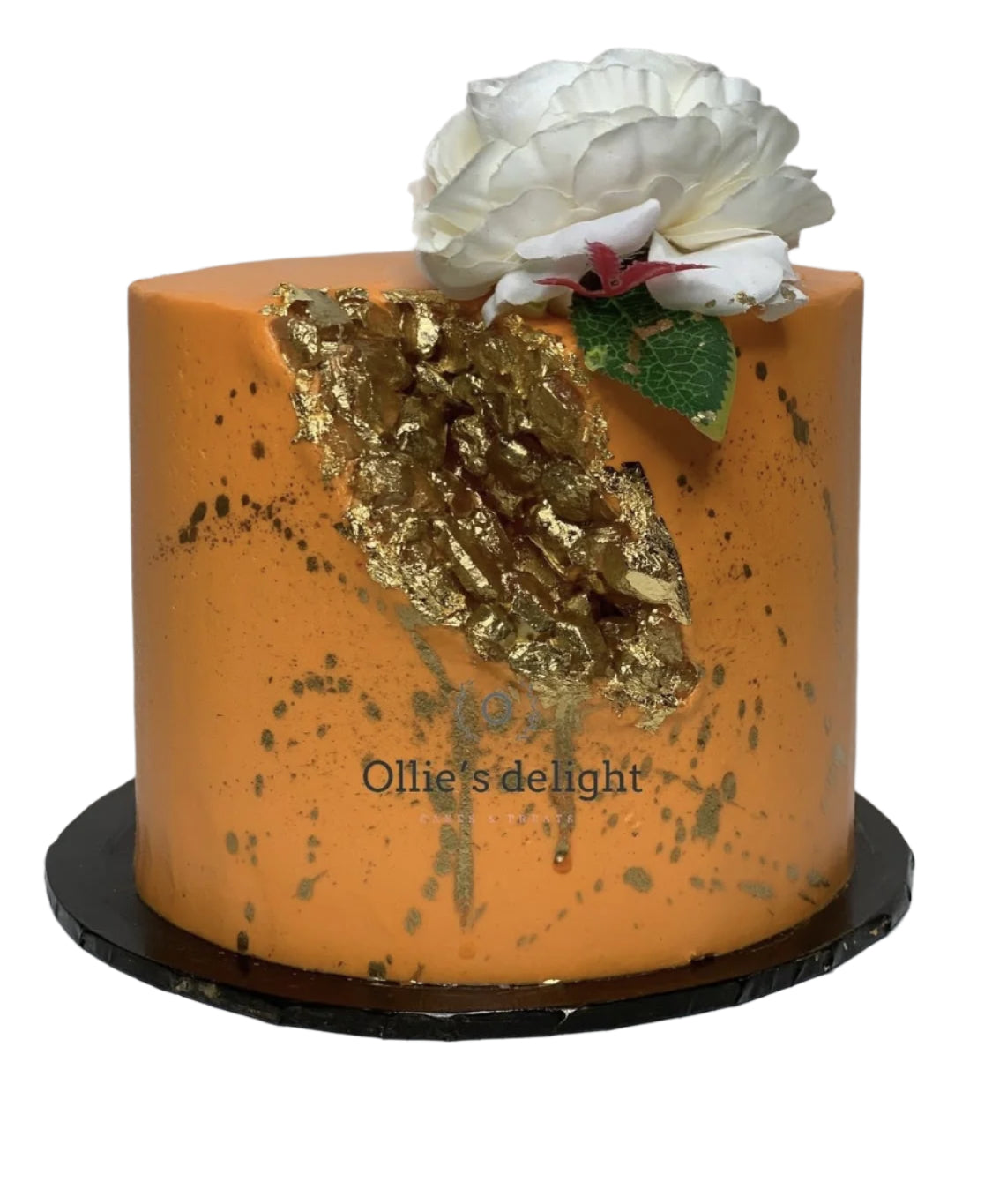 Elegant orange geode cake with edible gold crystal detailing and a white sugar flower on top, perfect for upscale celebrations.